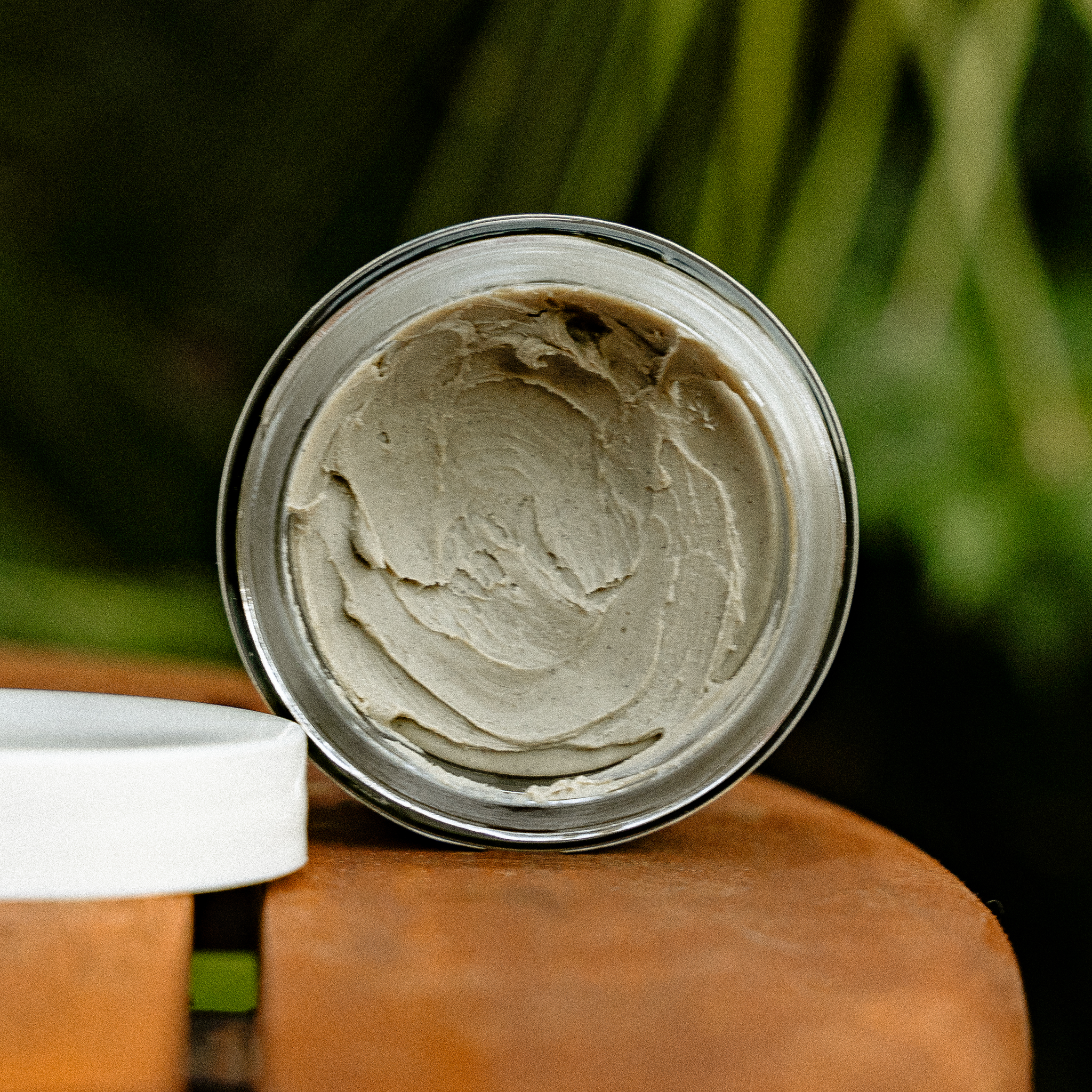 Close-up of Clay No. 34 matte hair clay — scooped texture inside open jar.